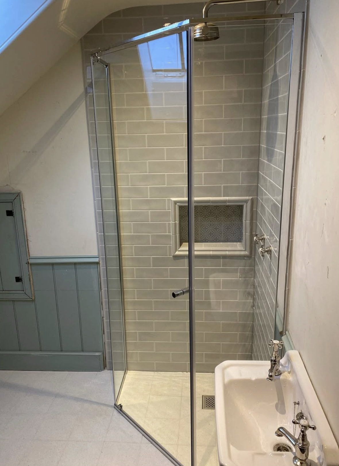 Bathroom with sage tiled walls and chrome fixtures